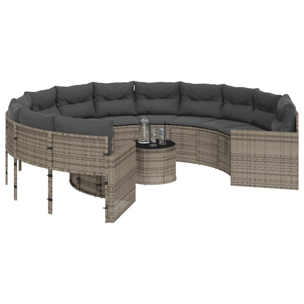 Pilka apvali sodo sofa su stalu ir pagalvėlėmis